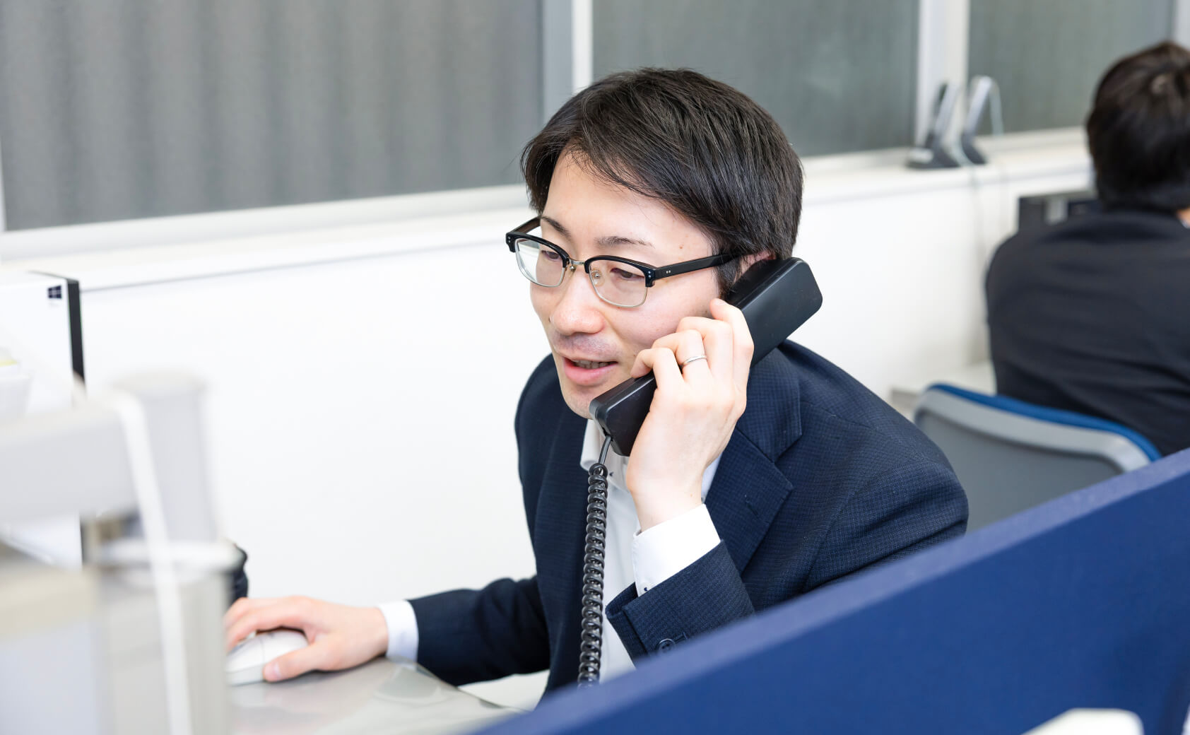 キービジュアル(男性従業員が電話対応している様子)